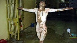 ATTN EDITORS: GRAPHIC CONTENT MORE ON IMAGE FORUM This handout photo from Australia's SBS TV released 15 February, 2006 according to the broadcaster SBS, allegedly shows a psychologically disturbed prisoner in Iraq's notorious Abu Ghraib jail, covered in a brown substance in Baghdad in 2004. Australian public broadcaster SBS 16 February 2006 defended its decision to show previously unseen pictures of the abuse of prisoners in Iraq's notorious Abu Ghraib prison by US troops. The producer of the Dateline programme which aired 15 February the photographs and videos, Mike Carey, dismissed complaints from Washington that the broadcast could further inflame anti-US sentiment and endanger troops in Iraq. PLEASE NOTE: ORIGINAL IMAGE OBTAINED BY SBS WAS ALTERED WITH BLURRING RESTRICTED TO EDITORIAL USE AFP PHOTO/HO/SBS DATELINE